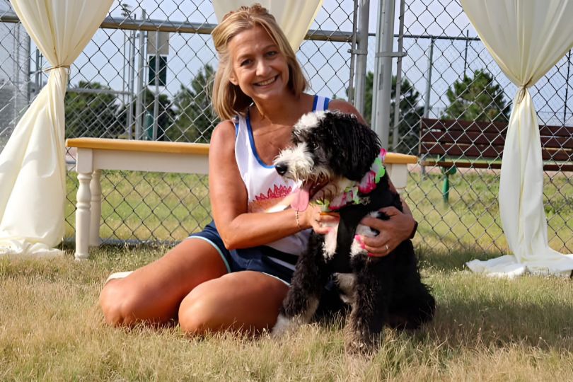 a lady holding a dog